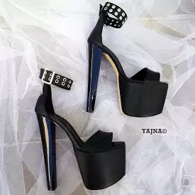 Black platform high heel shoes with single strap.